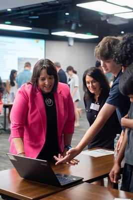 LG at Burlington HS with students looking at a laptop